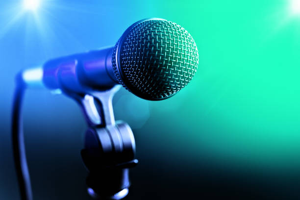 istock Vocal microphone with blue and green stage lights 1132210508
