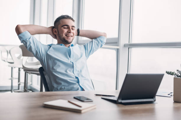 istock Young businessman working on his laptop in spacious bright office. 1132210687