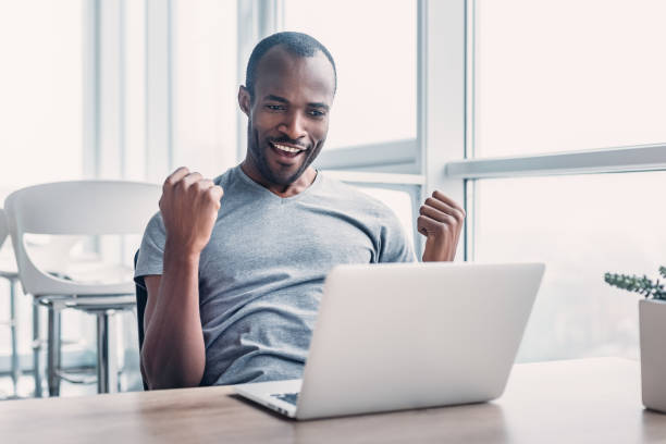 istock Young businessman working on his laptop in spacious bright office. 1132210701