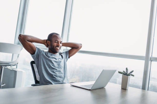istock Young businessman looking on the screen in spacious bright office. 1132210933