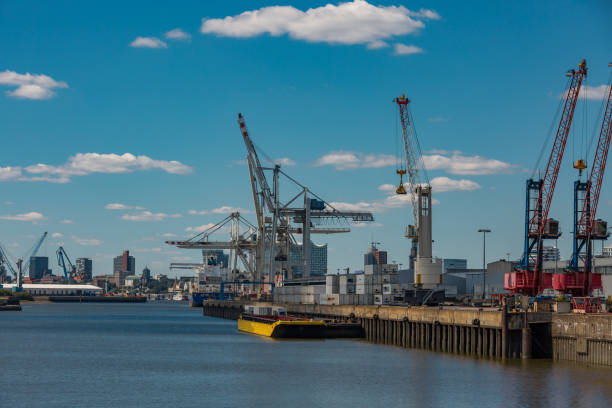 harbor cranes with working ship in the port of hamburg - hamburg germany harbor cargo container commercial dock imagens e fotografias de stock