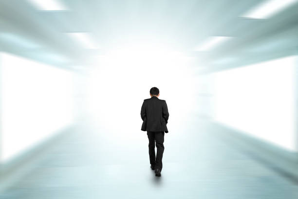 istock Rear view businessman walking through underpass toward bright side 1132212191