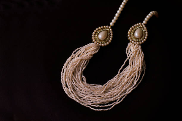 istock Multi row pearl necklace with small pearls on a black background. 1132212192