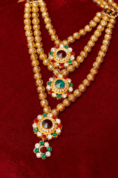 istock Multi layered artificial golden rani haar jewelry on a red background. 1132212283