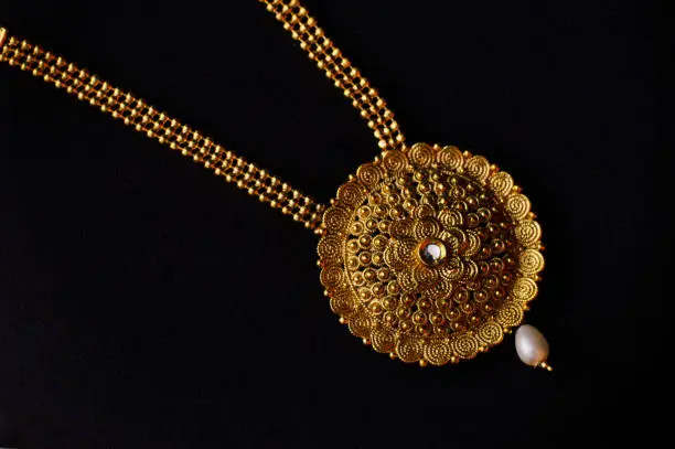 Artificial golden necklace on a black background
