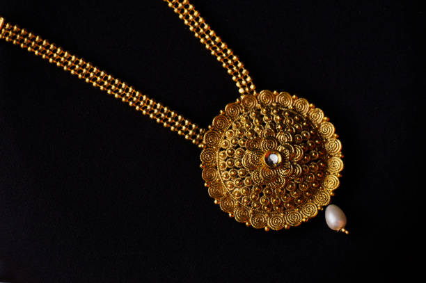 artificial golden necklace on a black background. - fake jewelry imagens e fotografias de stock