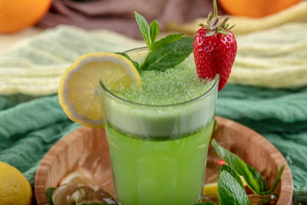 istock Lemonade with kiwi, green basil, grapefruit syrup and ice, selective focus. 1132213030
