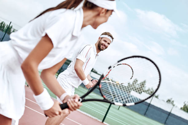 istock Active weekend together. Couple plays tennis 1132213058