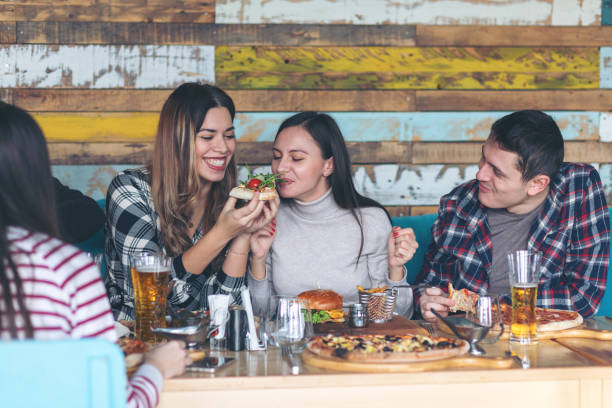 istock Happy young friends drinking beer and sharing pizza at bar restaurant 1132213109