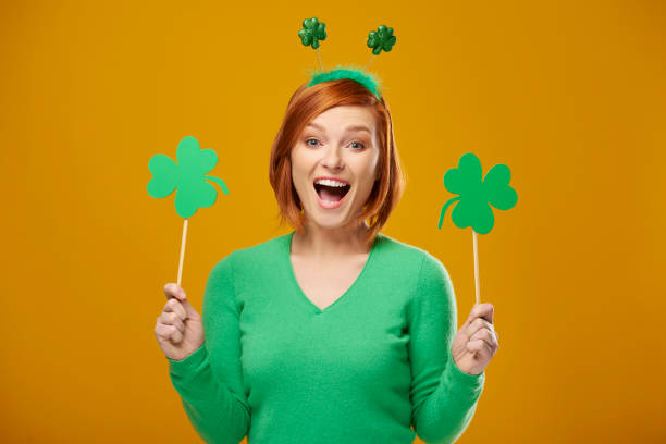 istock Screaming woman holding clover shaped banner with copy space 1132213632