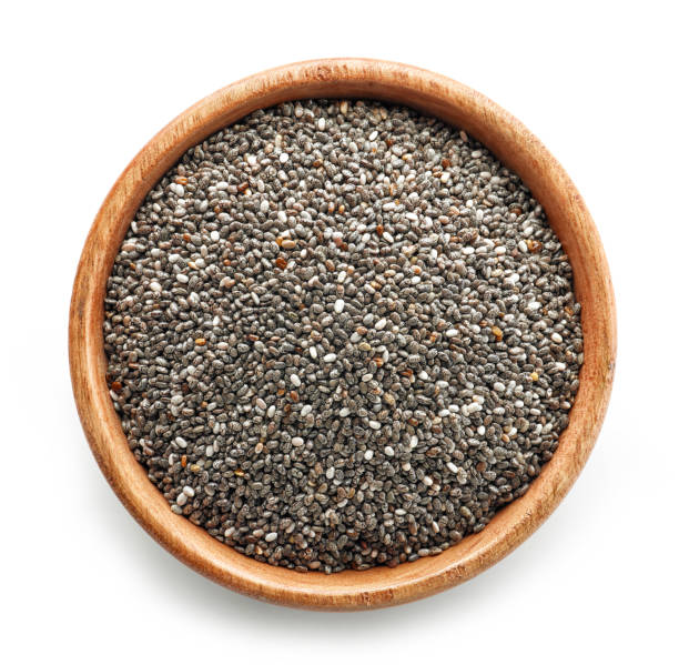 chia seeds in wooden bowl chia seeds in wooden bowl isolated on white background, top view salvia hispanica plant stock pictures, royalty-free photos & images