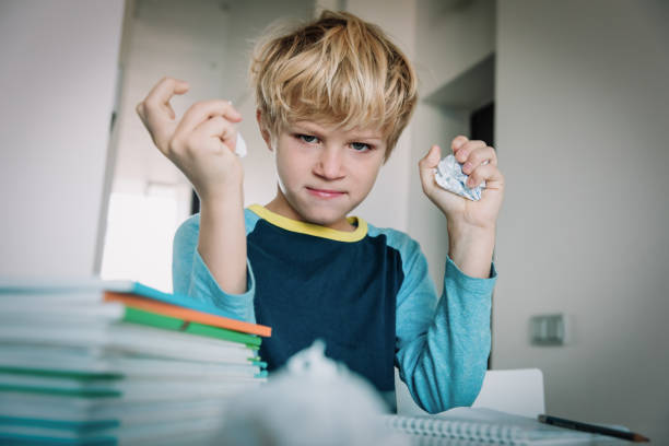 istock little boy tired stressed of doing homework, bored, agressive 1132214664