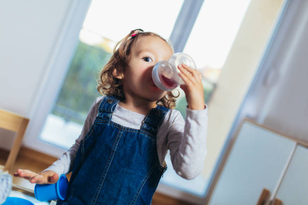 istock Adorable child drinking juice from bottle. 1132215119