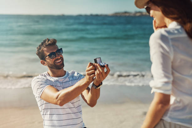 I choose you, every single day of my life Cropped shot of a young man proposing to his girlfriend at the beach on a summer’s day fiancé stock pictures, royalty-free photos & images