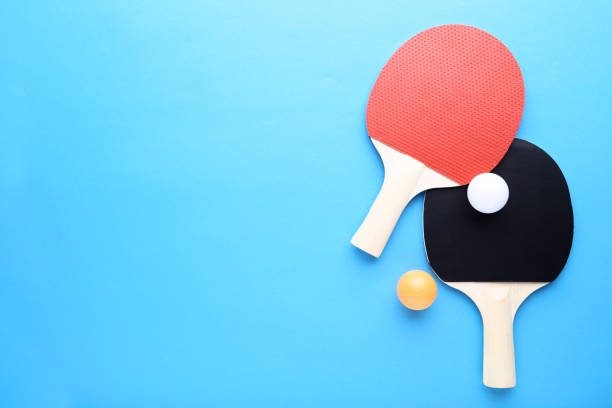 istock Table tennis rackets with balls on blue background 1132216381