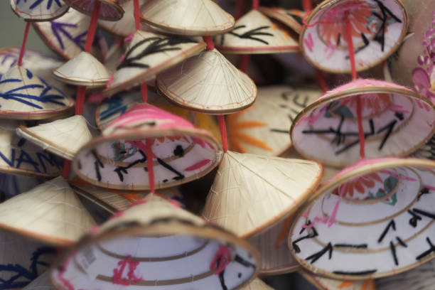 Garlands of traditional Vietnamese straw cone-shaped hats in a souvenir shop. Vietnam