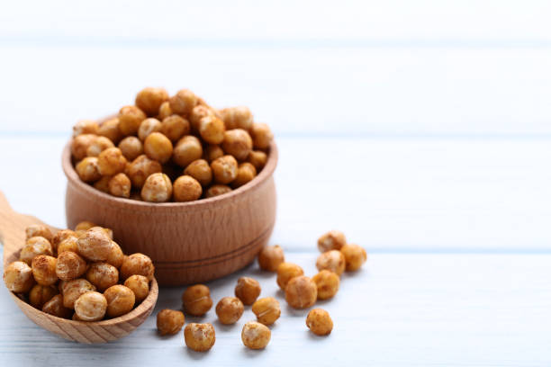 istock Roasted chickpeas in spoon and bowl on wooden table 1132216526