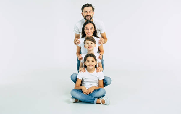 istock Happy cute smiling family looking on camera isolated on white studio 1132216654