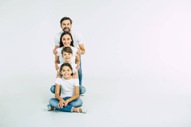 istock Happy cute smiling family looking on camera isolated on white studio 1132216657
