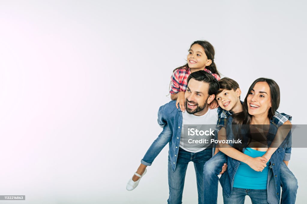 Photo of happy beautiful family isolated on white and looking away Family Stock Photo