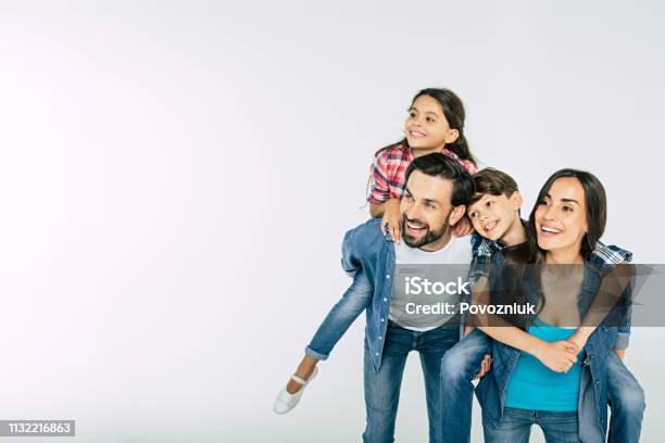 Photo Of Happy Beautiful Family Isolated On White And Looking Away Stock Photo - Download Image Now