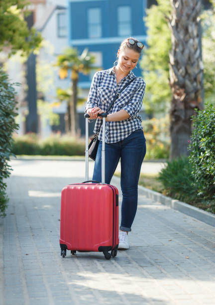 istock Girl walking around city with suitcase 1132218379