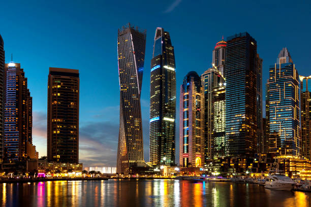 Luxurious Dubai marina skyscrapers and yachts at blue hour