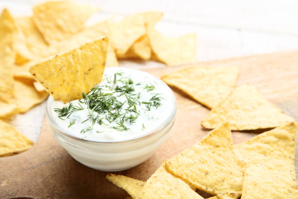 istock Potato chips with sauce and green dill on wooden table 1132219679