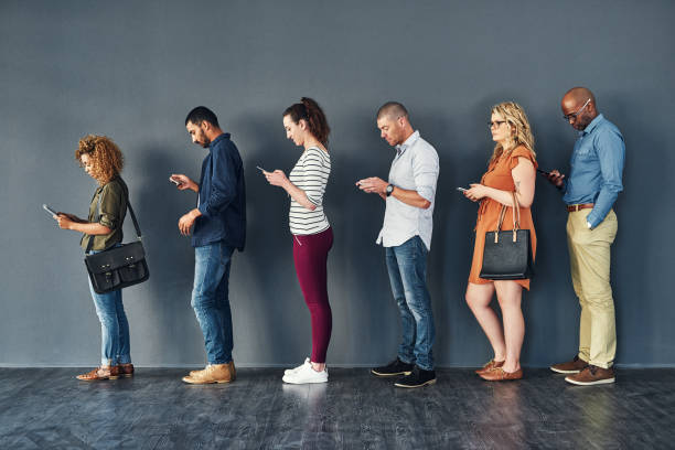 istock Keeping busy on their phones while they wait 1132219773