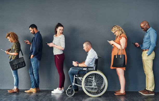 Bridging the gap to create equal opportunities for all Studio shot of people waiting in line against a grey background people in a row photos stock pictures, royalty-free photos & images