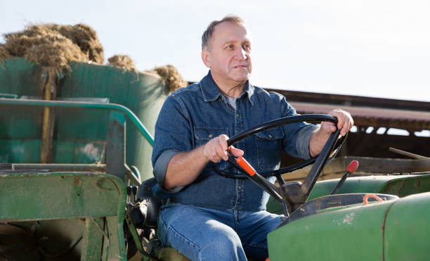 istock Confident mature man farm owner driving tractor 1132222168