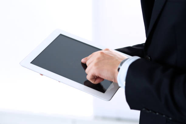 istock Unknown businessman using digital tablet in office background. Business concept 1132222684