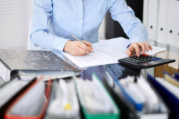 istock Unknown bookkeeper woman or financial inspector  making report, calculating or checking balance, close-up. Business portrait. Audit or tax concepts 1132222780