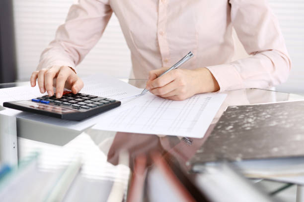 istock Unknown bookkeeper woman or financial inspector  making report, calculating or checking balance, close-up. Business portrait. Audit or tax concepts 1132222782