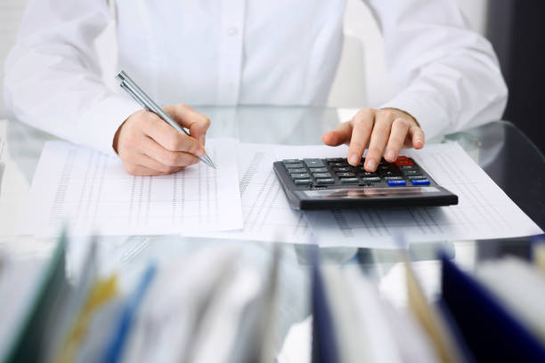 istock Unknown bookkeeper woman or financial inspector  making report, calculating or checking balance, close-up. Business portrait. Audit or tax concepts 1132222785