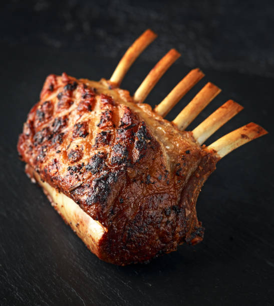 istock Lamb rack roasted with herbs on stone board 1132223606