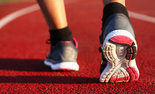 istock Woman running on athletic track 1132223639