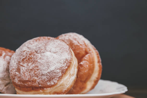 istock delicious donuts sprinkled with powdered sugar with filling on a dark background 1132224325
