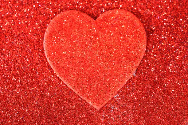 Defocused red glitter with heart