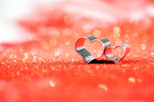 Hearts on defocused red glitter