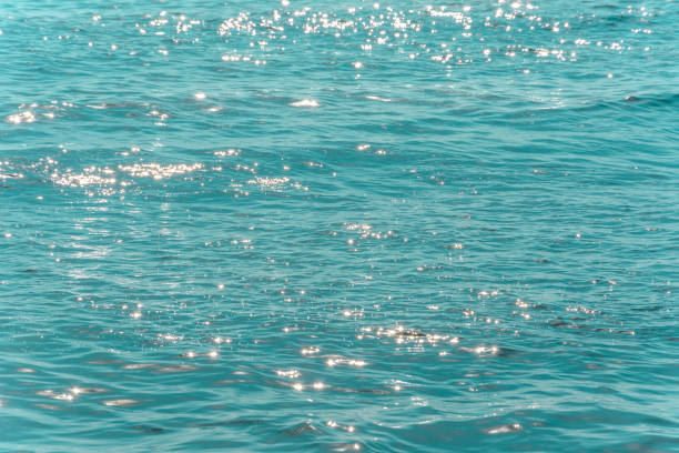 istock turquoise sea surface with bright shiny lights from the sun 1132227841
