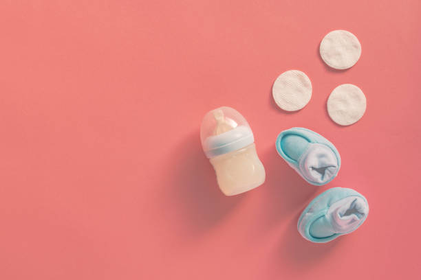 istock Baby booties and milk bottle, top view 1132231075