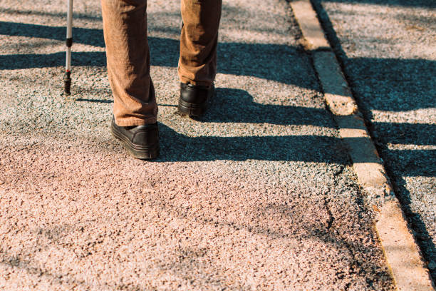 istock Senior male walking with stick on street 1132232206