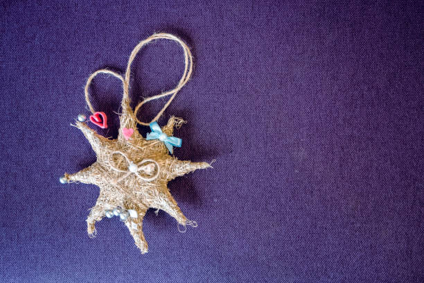 istock Octagonal new year star made of straw on a purple background. Handwork. 1132233291