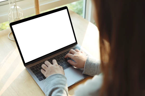 istock Women using laptop with blank screen at table in the office. 1132236517