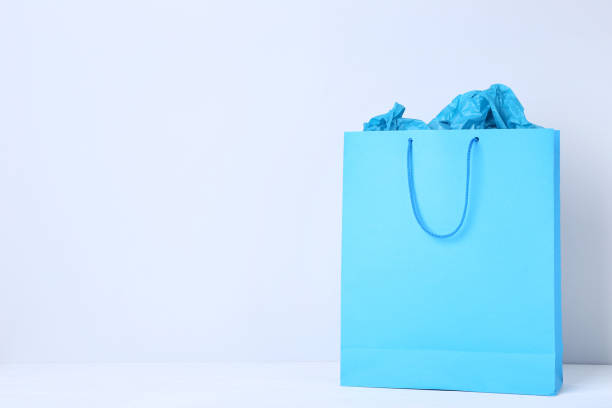 istock Blue shopping bag on gray background 1132238452