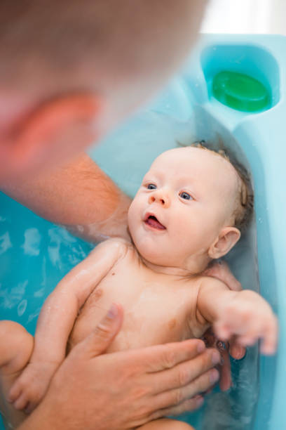 istock Happy baby boy taking bath with his daddy 1132239468