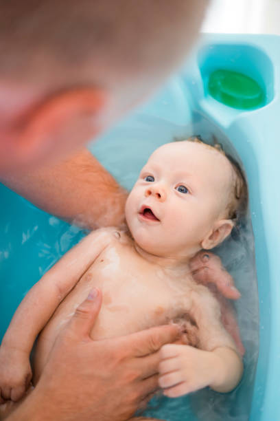istock Happy baby boy taking bath with his daddy 1132239470