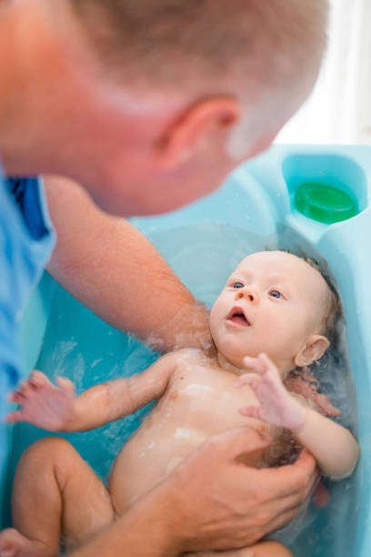 istock Happy baby boy taking bath with his daddy 1132239471