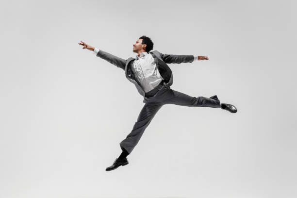 istock Happy businessman dancing isolated on gray studio background 1132239772